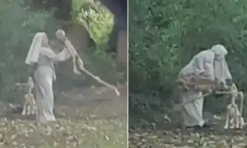 കന്യാസ്ത്രീയുടെ ഗൗണ്‍ ധരിച്ച് സെമിത്തേരിയില്‍ അസ്ഥികൂടത്തിനൊപ്പം നൃത്തം ചെയ്ത് സ്ത്രീ: വൈറലായി ചിത്രങ്ങള്‍