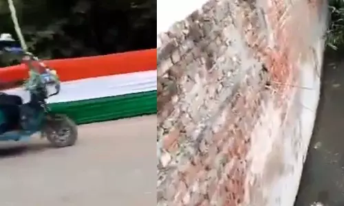 യോഗിയുടെ സന്ദർശനത്തിനുമുൻപ് അഴുക്കുചാൽ ത്രിവര്‍ണ പതാക കൊണ്ട് കെട്ടിമറച്ചു