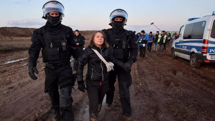 Police officers detain climate activist Greta Thunberg