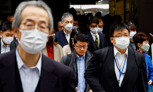 Masks stay put in Japan as 3-year request to wear them ends