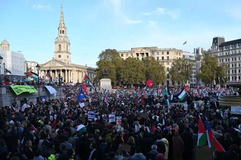 Protesters gather with placards and flags during the London Rally For Palestine
