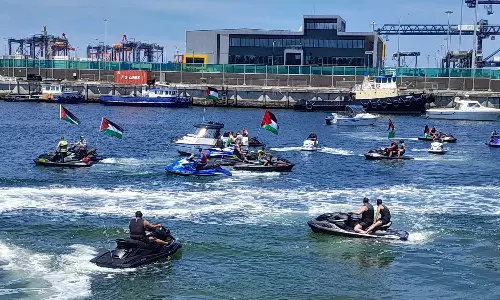 Protesters on jet skis, small boats block Israeli cargo ship from docking at a Sydney port, Australian protesters block Israeli cargo ship at a Sydney port