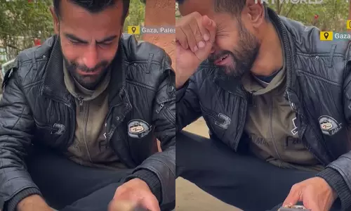 father wrapped the hands of his slain son around a packet of biscuits in gaza
