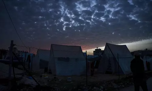 Palestinians are seen around their makeshift tents