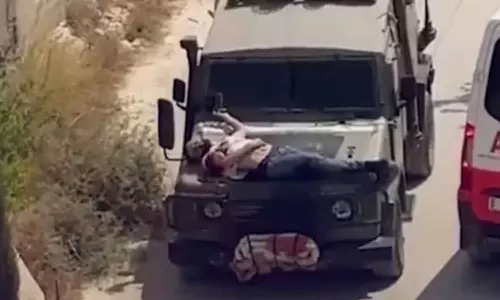 Israeli forces strap Palestinian man to jeep Israeli forces strap Palestinian man to jeep