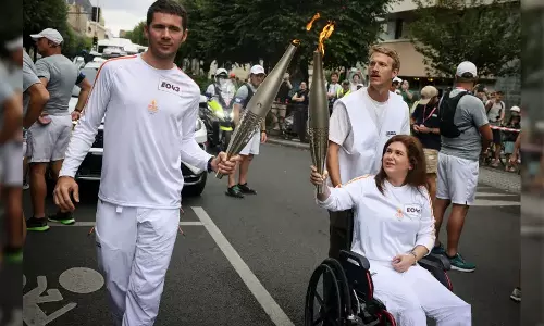 journalist wounded in Israeli strike carries Olympic torch