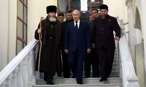 Russian President Vladimir Putin kisses Quran in his first visit to Chechnya in nearly 13 years