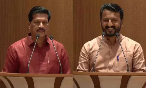 Speaker presents blue trolley bag to new MLAs