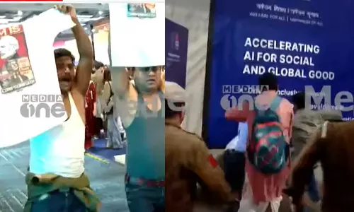 ഇന്ത്യ-യുഎസ് വ്യാപാര കരാർ; എഐ ഉച്ചകോടിയിൽ പ്രധാനമന്ത്രിക്കെതിരെ വസ്ത്രമൂരി പ്രതിഷേധം