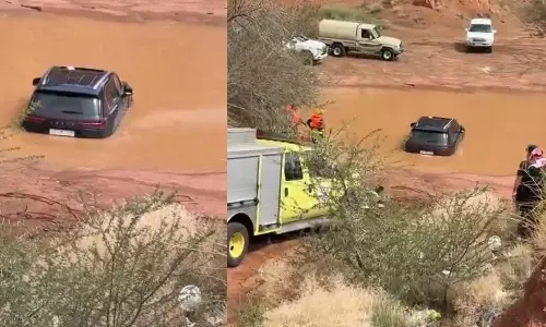 Two people were rescued after being trapped in a vehicle in a flash flood in Hail